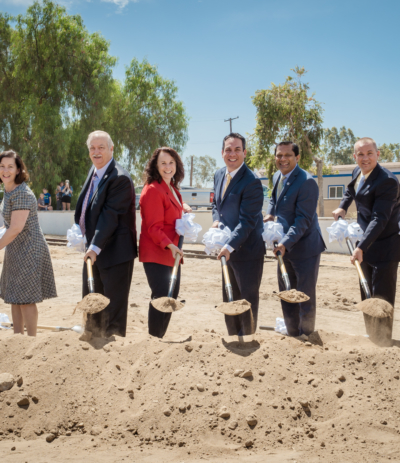 SBCTA board members with shovels in front of sand